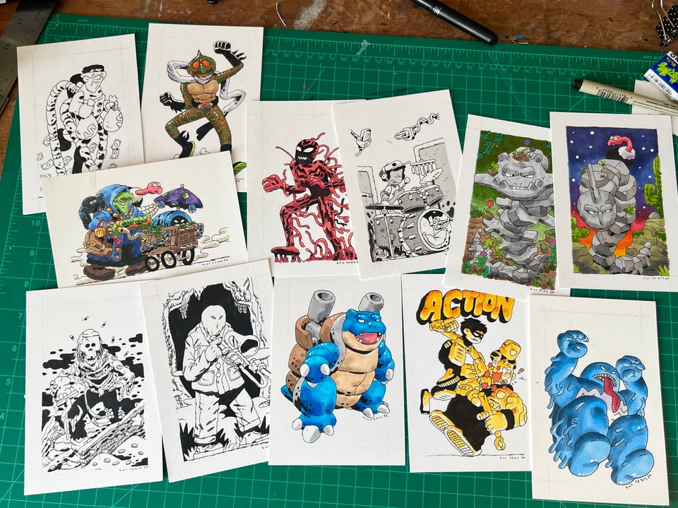 a picture of a stack of original drawings on a desk