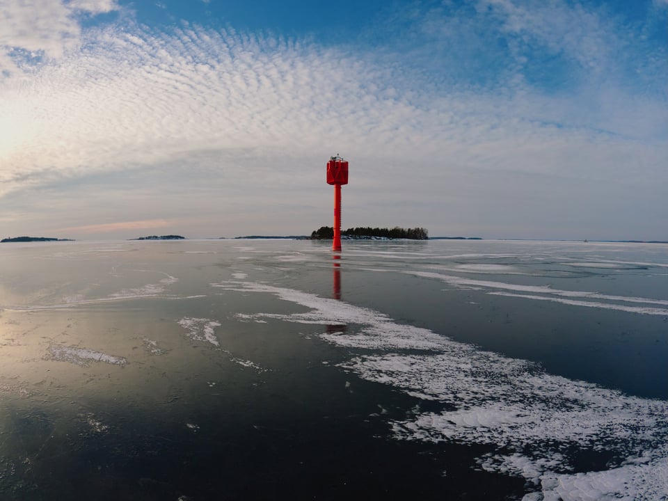 A big orange beacon surrounded by ice.