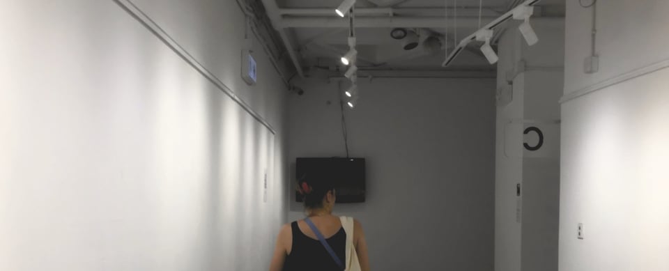 Amanda in an empty exhibition room