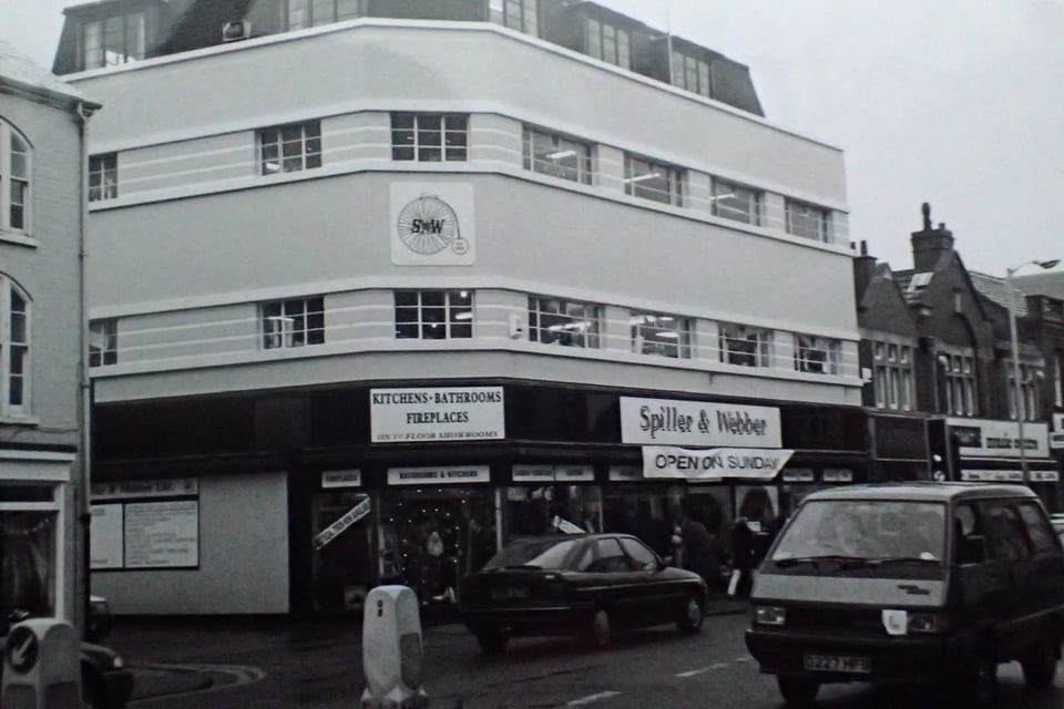 A black and white photo of the building when still the Spiller and Webber store. The render is clean and the windows have not been painted up.