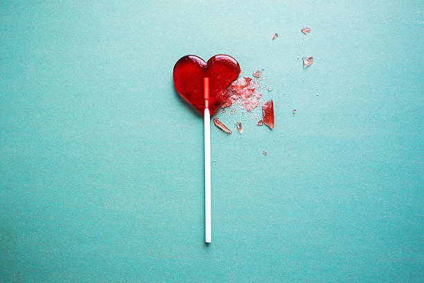 a lollipop shaped like a heart that's broken