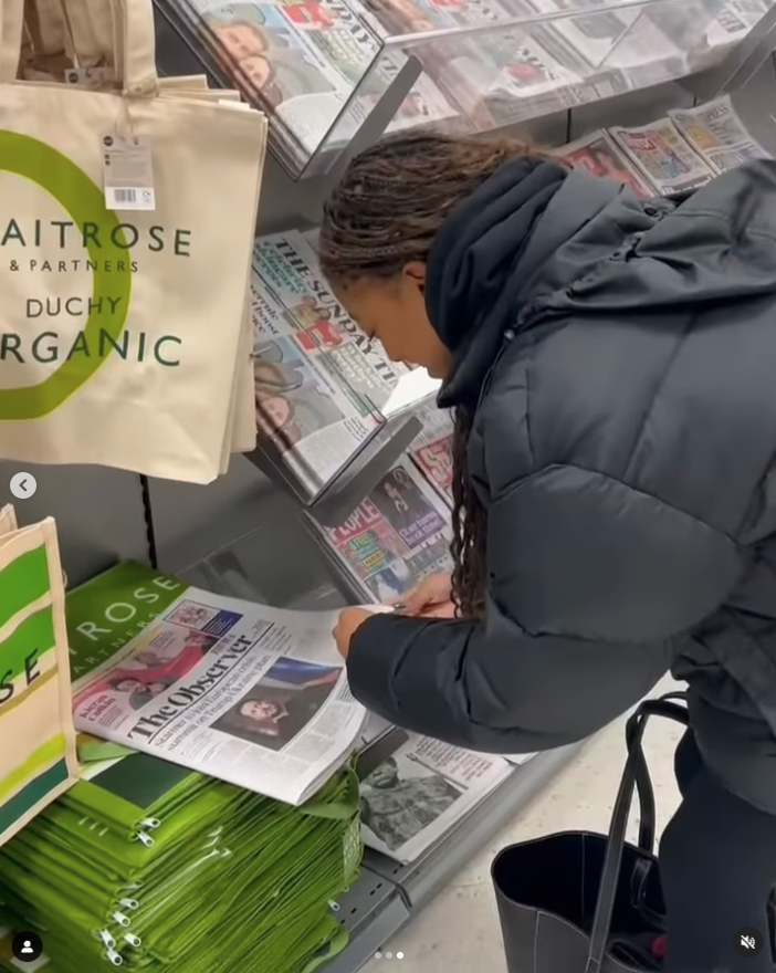 Video of me leaning down in a supermarket about to open up a copy of The Observer.