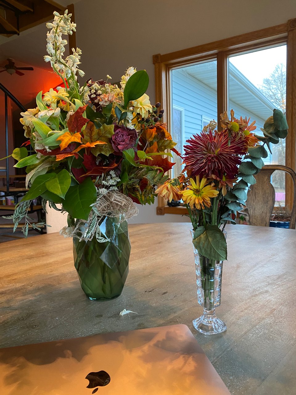 A large flower bouquet and a small vase of flowers