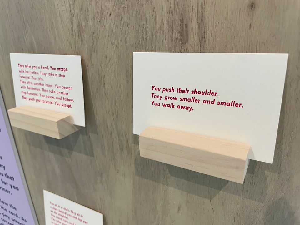 two cards, one of which reads "You push their shoulder. They grow smaller and smaller. You walk away."