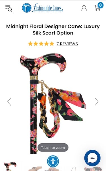 Photo of a floral print cane with a scarf attached.