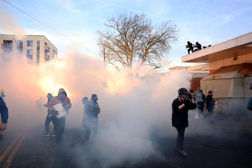 Image of protestors being gassed in Portland by federal agents