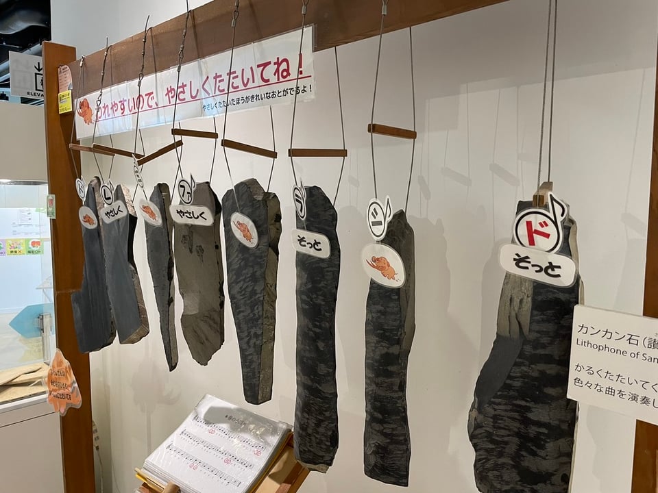 A xylophone made from hanging eight rock slabs in a row.