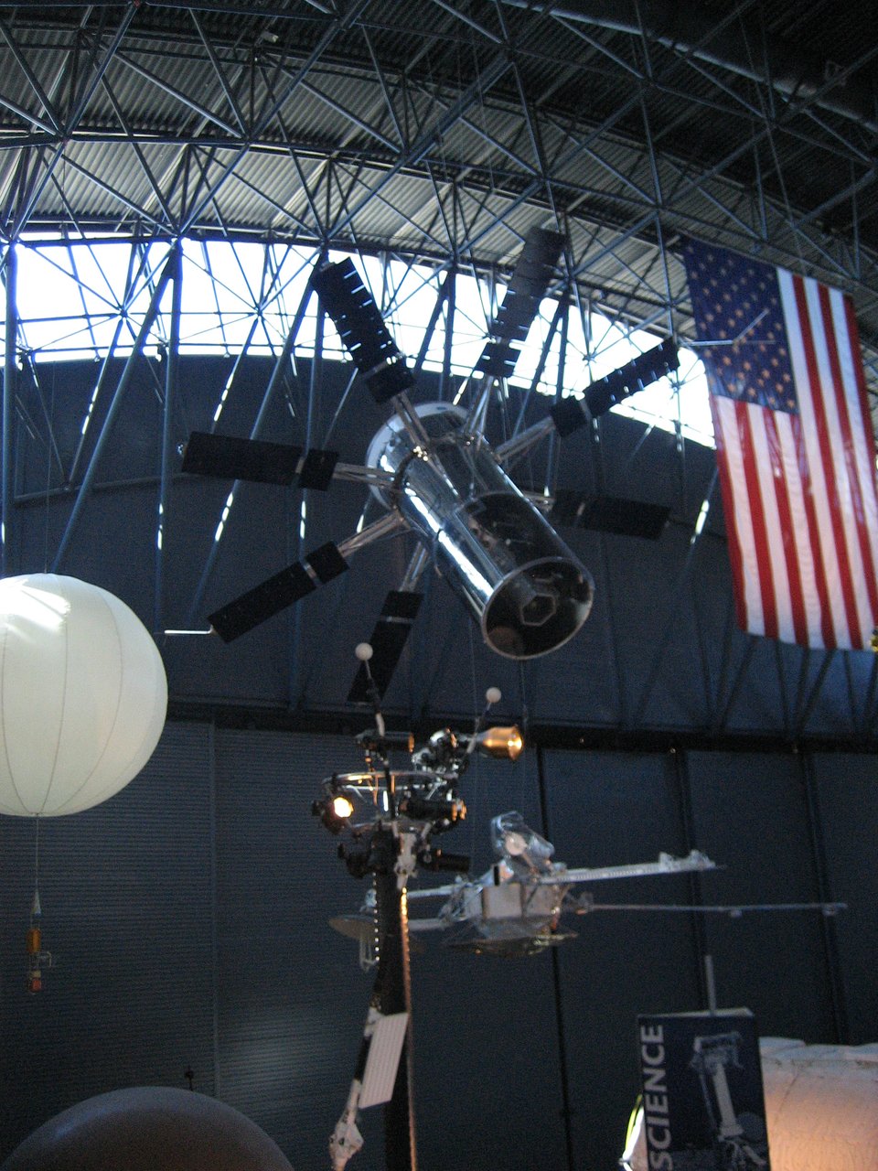 A cylindrical satellite with vanes sticking out.