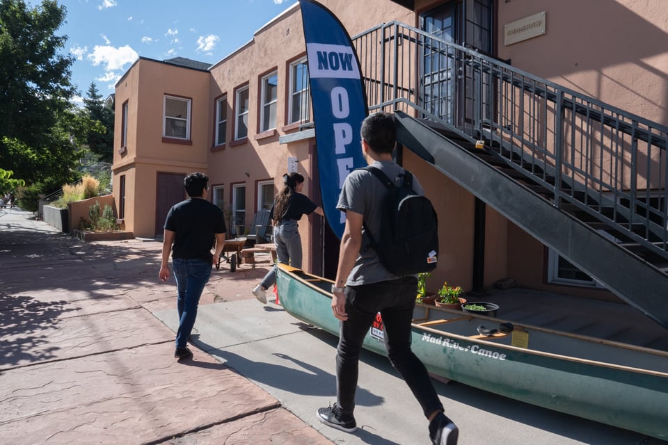 A group walking into a gallery.
