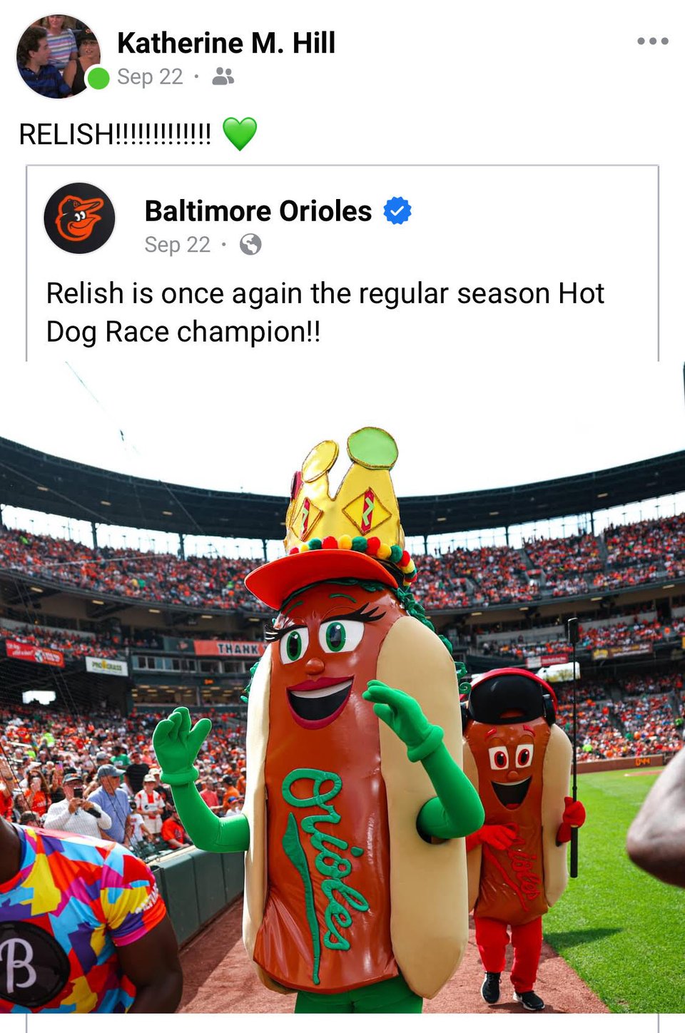 A Facebook screenshot. The Orioles posted "Relish is once again the regular season Hot Dog Race champion!!" Relish is wearing a crown and on the field at Camden Yards. I wrote, "RELISH!!!!!!!!!" and a green heart emoji.