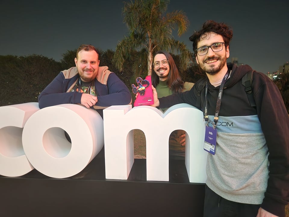 Nico posing with Enrique and Andre, celebrating the Best LATAM game award
