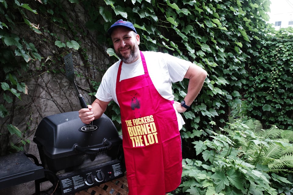 Me wearing the red KLF apron, which reads "The fuckers burned the lot."