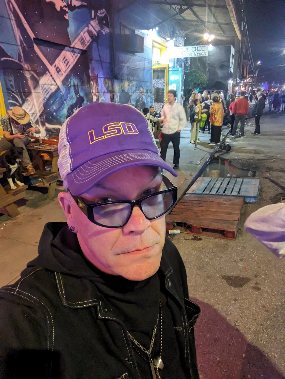 Blake on Frenchmen St in New Orleans wearing a hat that says LSD