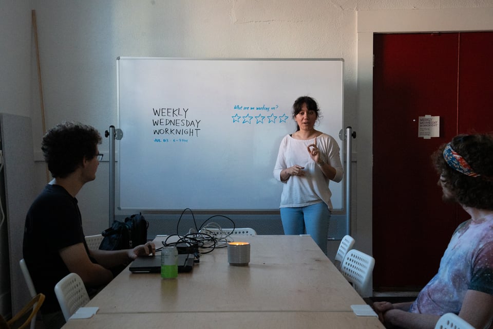 Livvy at the whiteboard saying something.