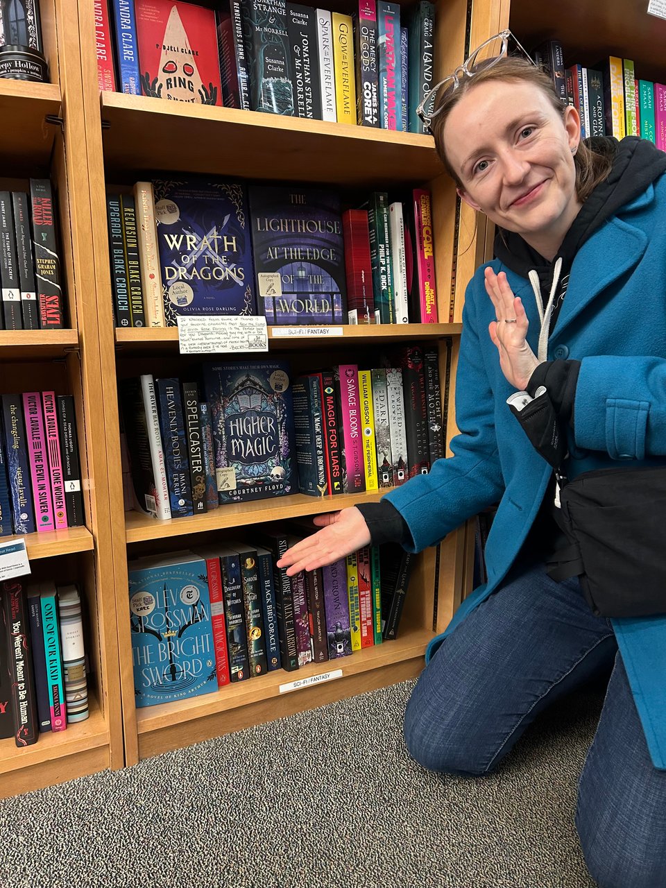 Me, gesturing to where my book is face out on the shelf at Yankee Bookshop, on my birthday.