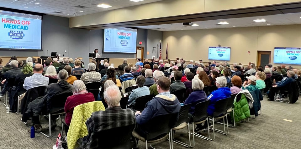 photo of me talking before a crowd of ~150 in a big room