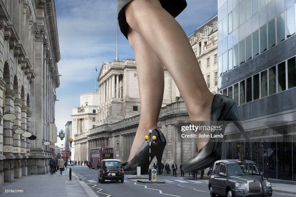 A Photoshopped image of a giantess in business skirt and heels walking through downtown London. Credit: John Lamb, Getty Images