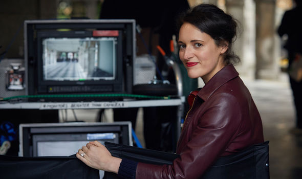 Phoebe Waller-Bridge turns to look at the camera as she sits in front of monitors on the filming set of Killing Eve