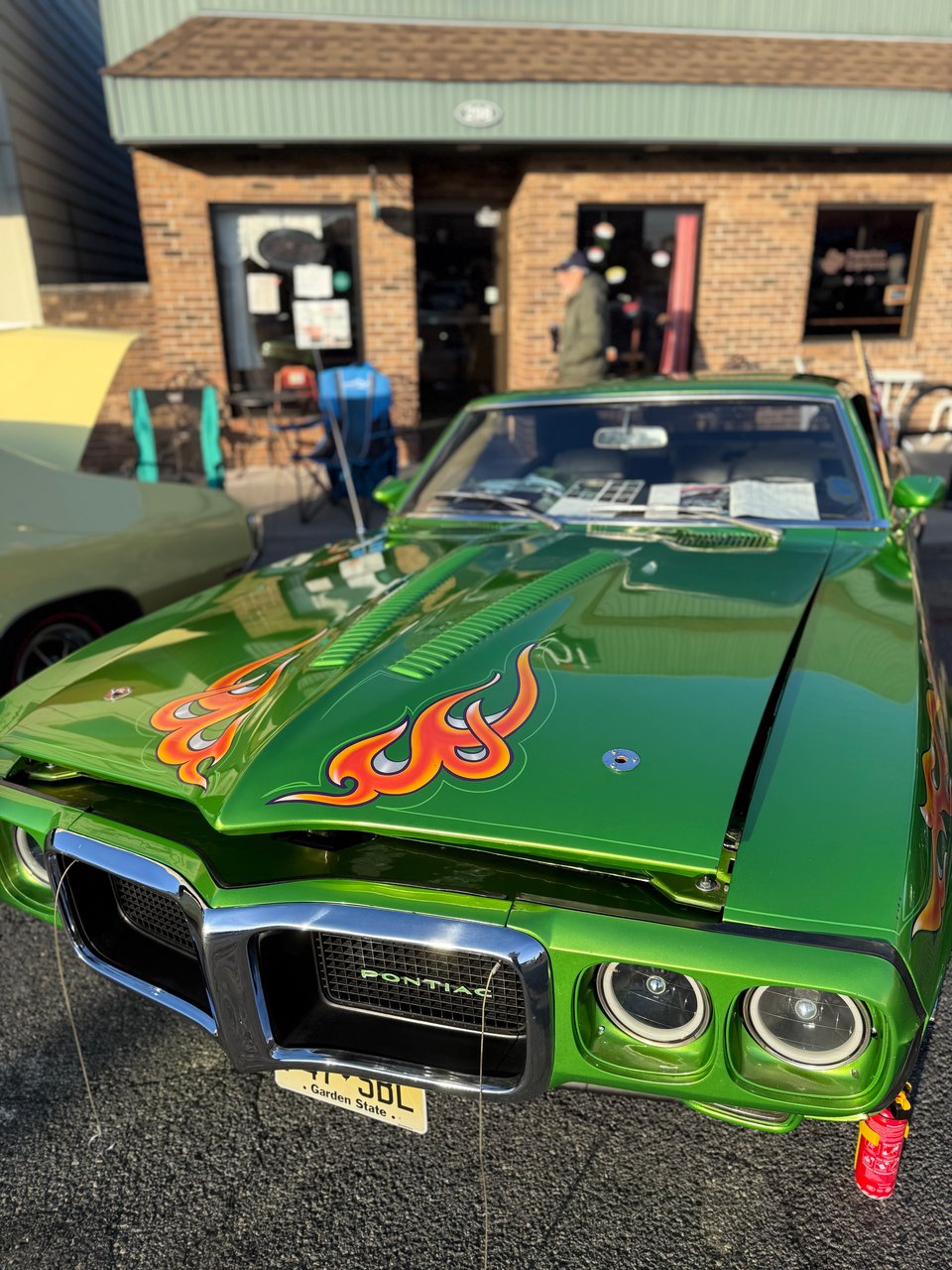 photo of green Pontiac Thunderbird with flames painted on the hood
