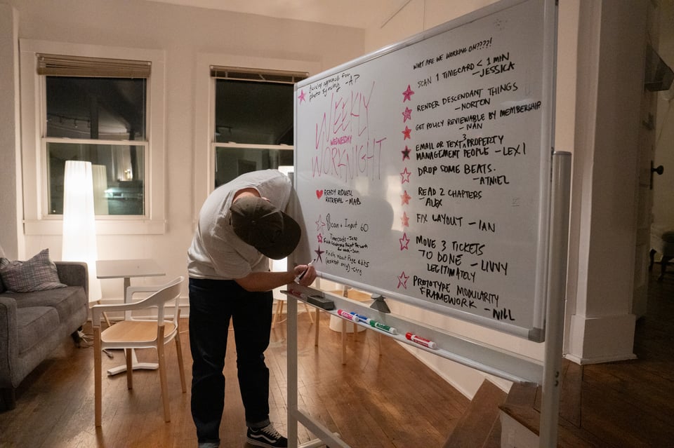 Chris filling in a star on the whiteboard.