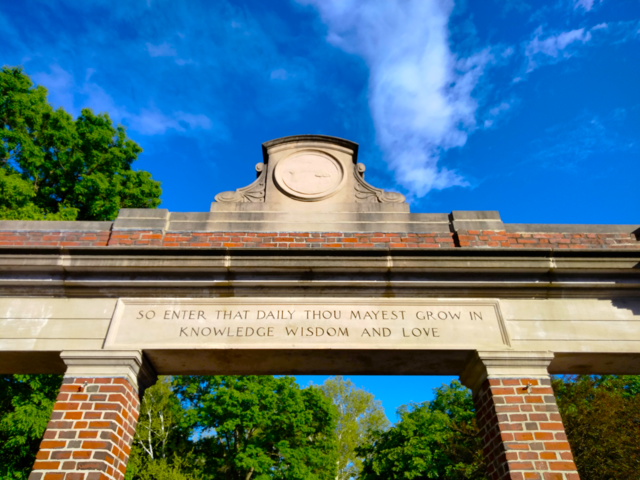 an archway with a quote on it
