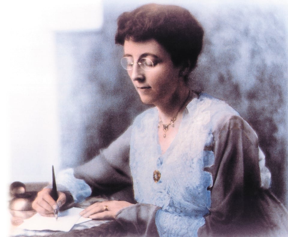 Photo of author L.M. Montgomery writing at desk