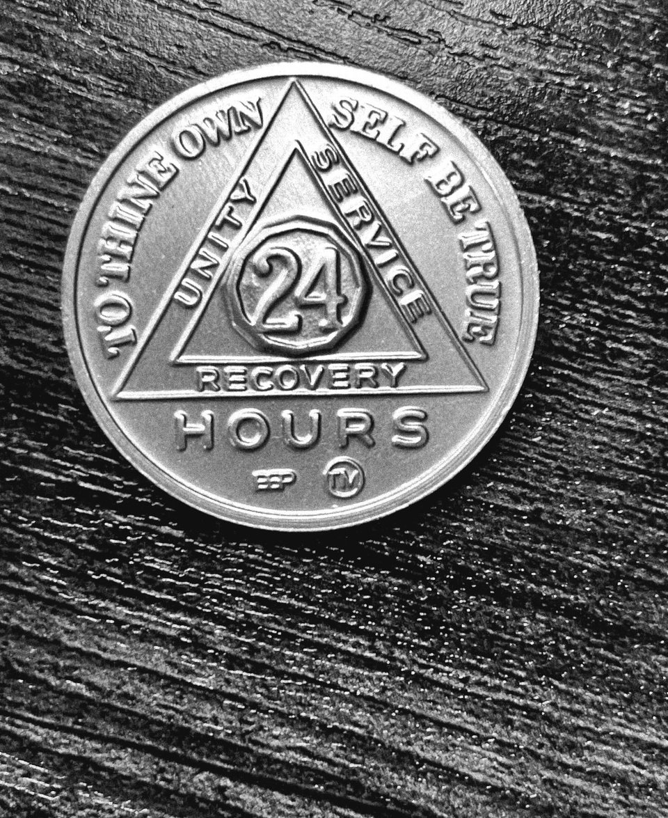 a coin with the words recovery hours on it