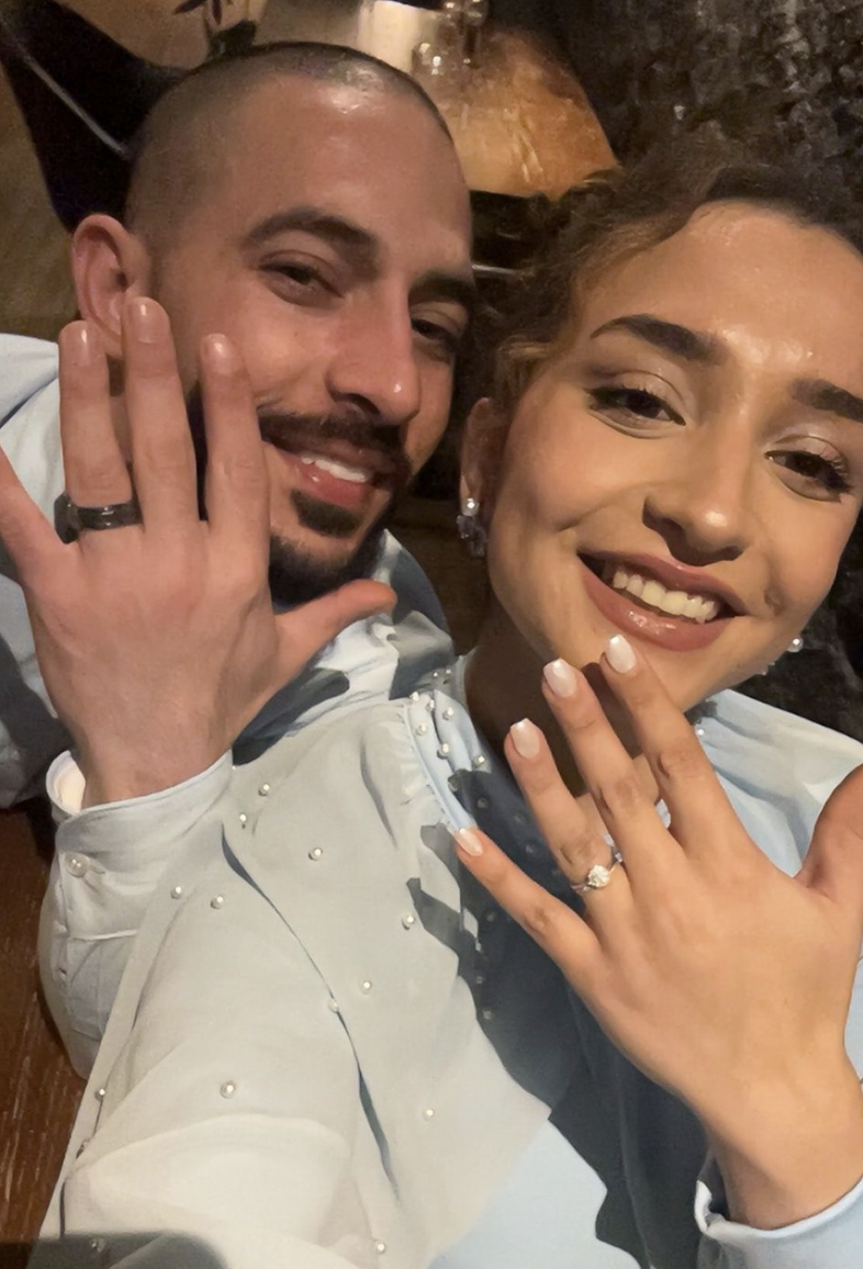 Aboud and Majdal smiling and showing their wedding rings