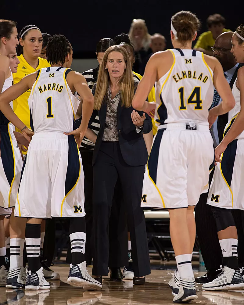 Kim Barnes Arico coaching her first game at Michigan in November 2012. She is wearing a business suit.