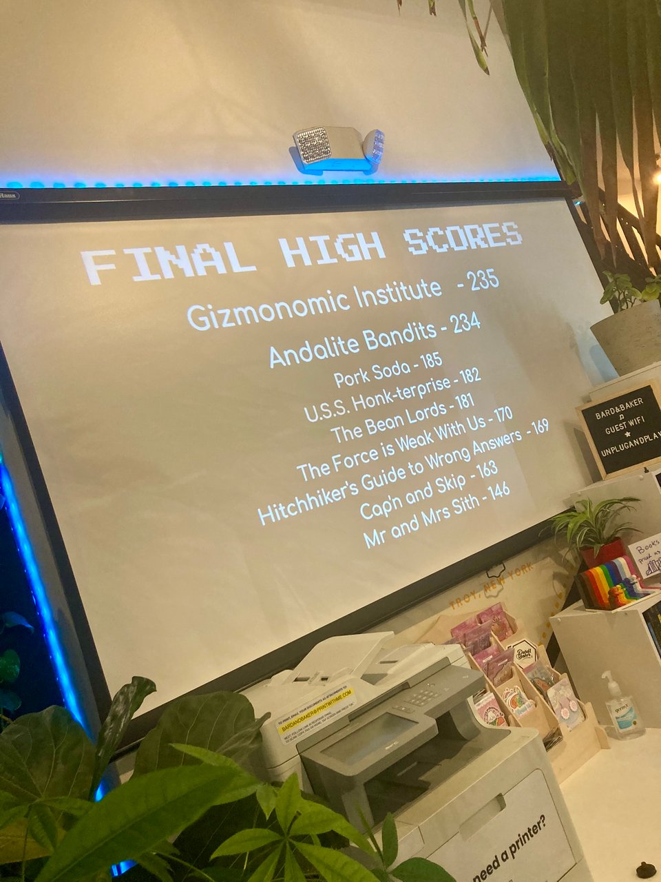 a projector screen showing the rankings for a round of trivia. a team named Andalite Bandits is in second place with 234 points.