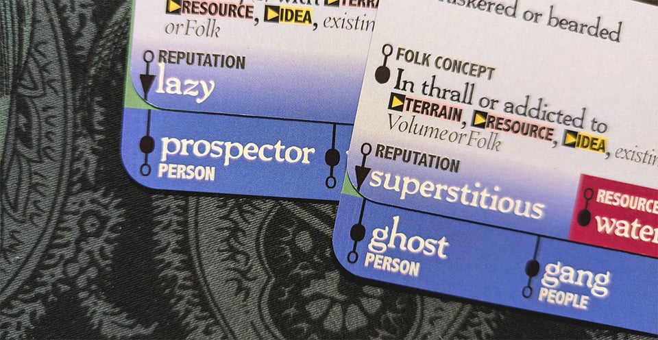 Downcrawl deck cards aligned to form the prompts "lazy prospector" and "superstitious ghost."
