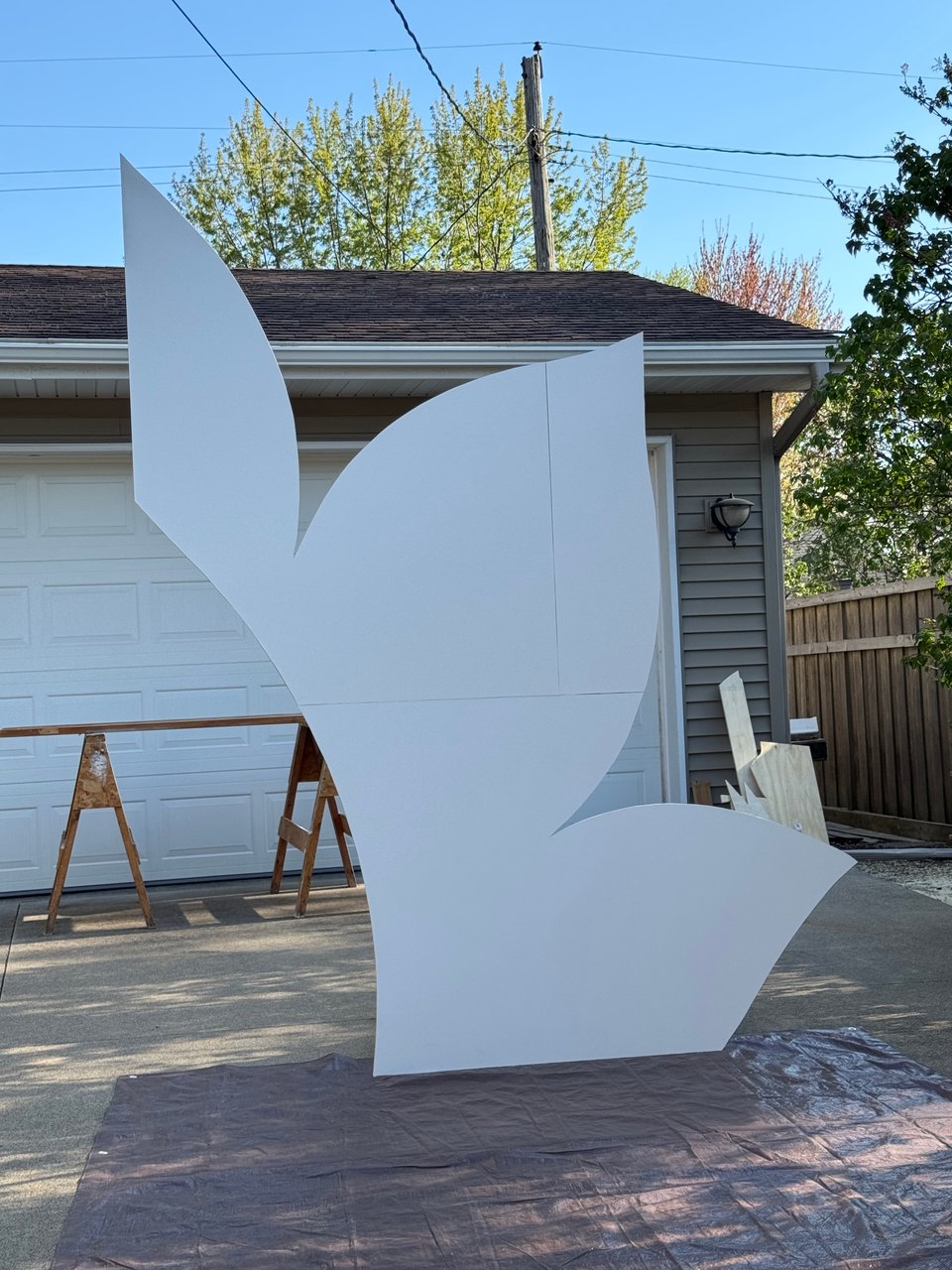 Half of a white lotus archway standing on driveway