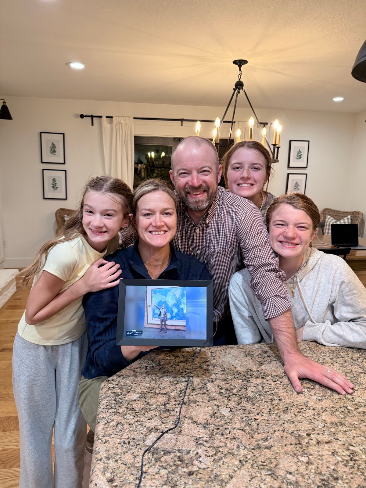 Our family holding the P-Day Emails digital picture frame