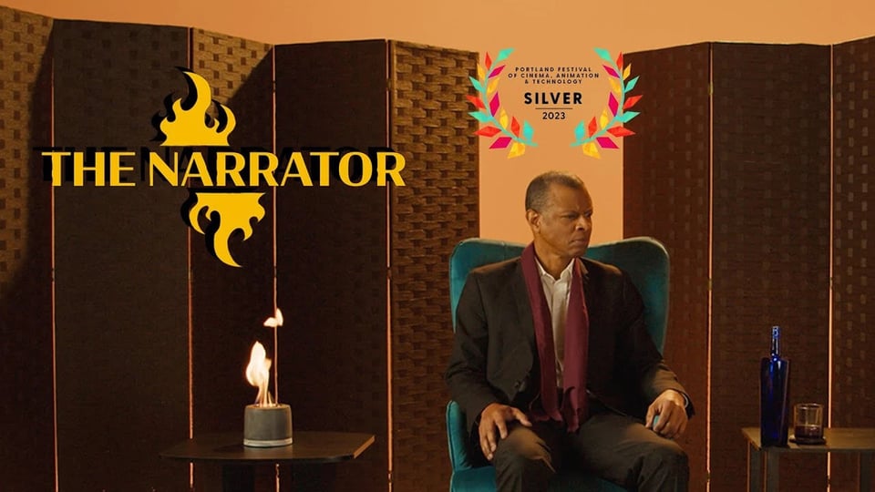 A YouTube thumbnail for a short film. A stylized font reads The Narrator. A pensive man sits in a chair next to a small bowl of fire