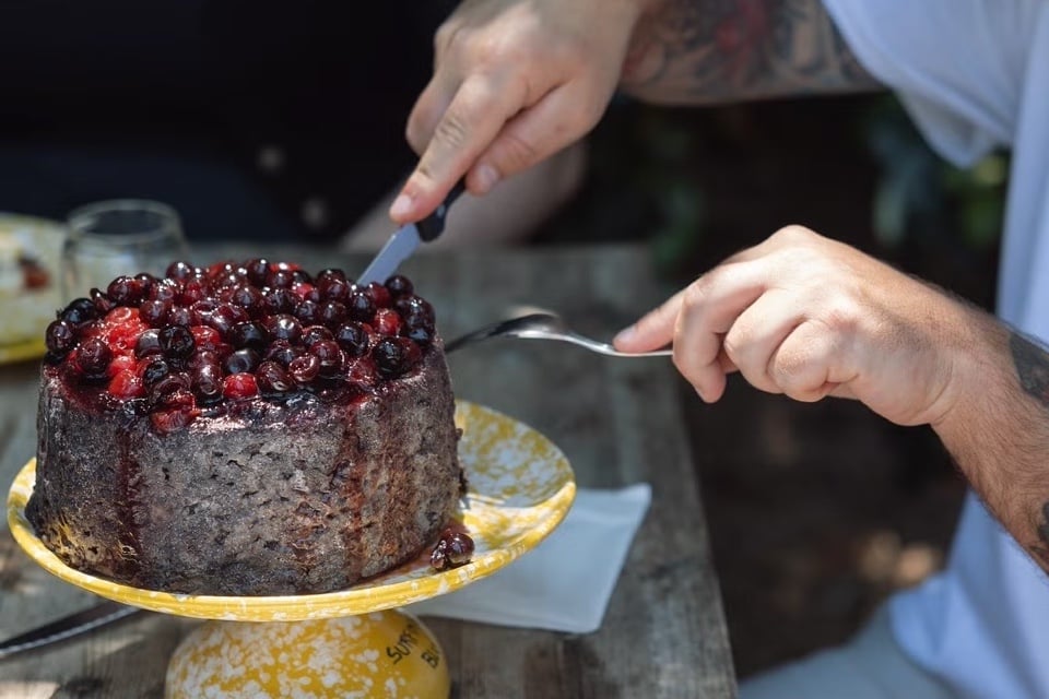 Amore Primitivo, a blue cheese aged in Primitivo wine for 100 days and then crowned with a tangle of deep maroon cherries.