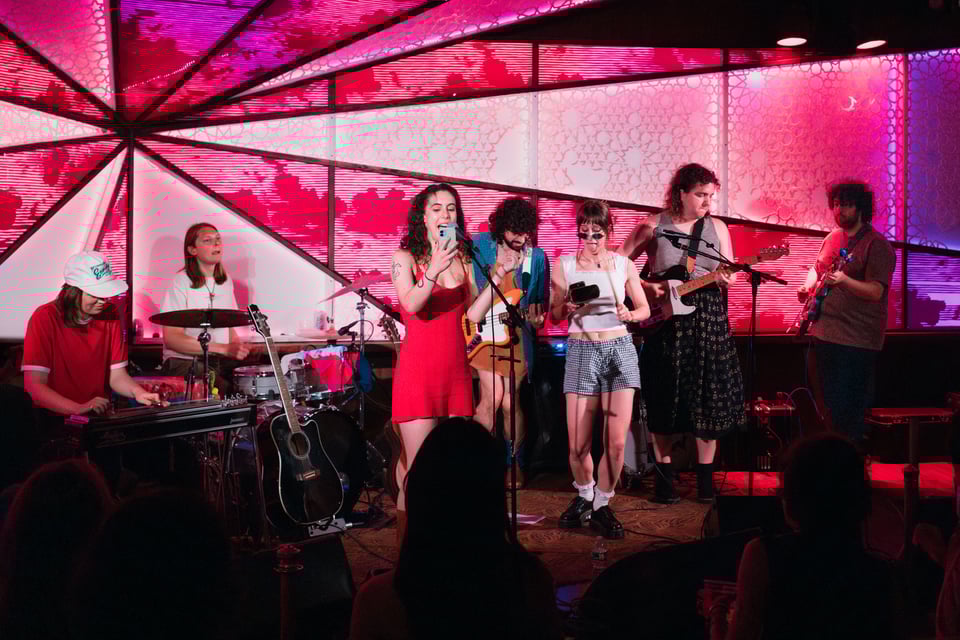 Gemma sings, Taylor plays cowbell, everyone jams - it's a cover of "Man, I Feel Like a Woman"