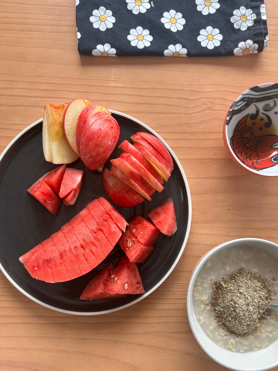 a photograph of a dining room table with watermelon and oatmeal.