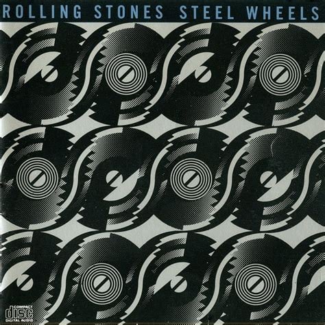 A arrangement of black circles that suggest vinyl albums and also the "steel wheels" of the title. There's six going horizontally across the top, five across the middle, and five across the bottom. There's also a stylized stripe across from one record to the other, suggesting an S, presumably for "Stones" or "Steel." It's possible the album is supposed to suggest the cover of The Rolling Stones' SOME GIRLS, which if so, lol.