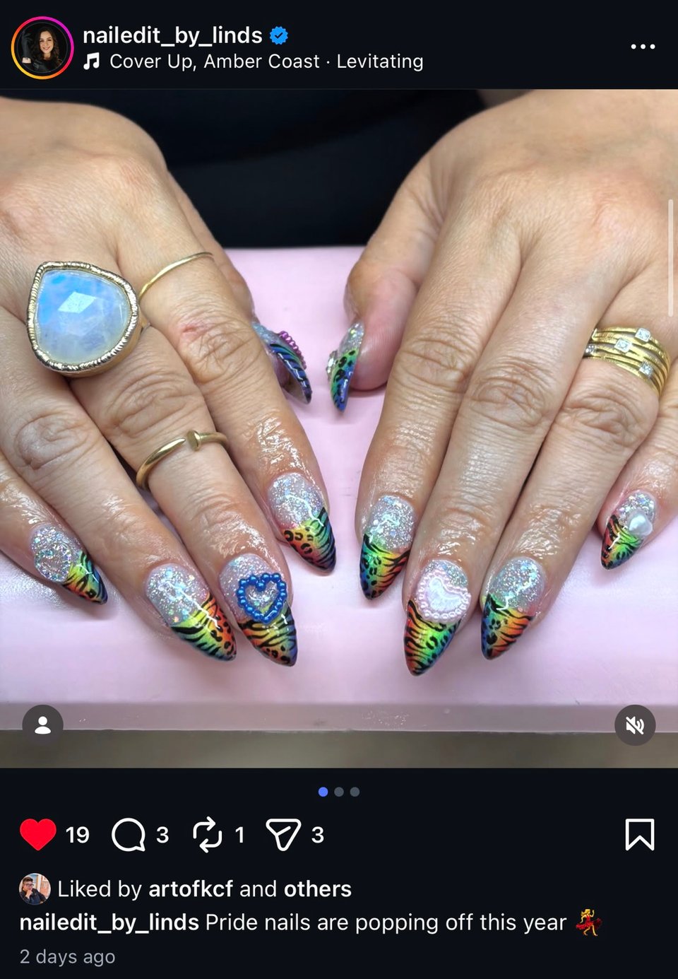 A screenshot of an IG post by my nail tech Nailed it by Lind of my pride nails glitter and rainbow leopard with heart charms