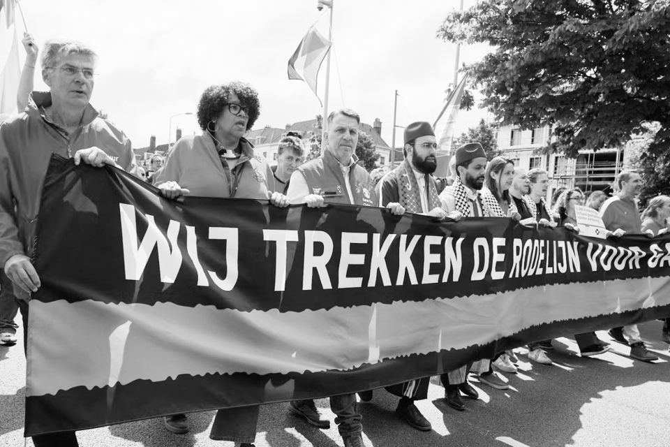 Protesters hold a banner reading, translated, 'we draw the red line for Gaza'