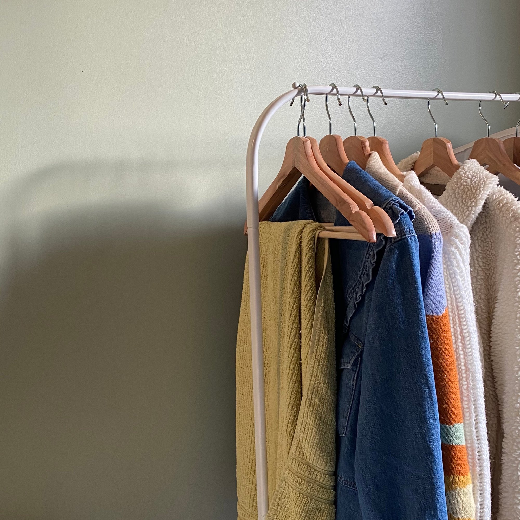 Image of a clothing rack and its shadow.