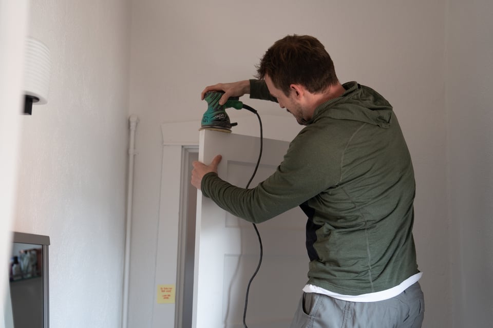 Mike sanding down a door.