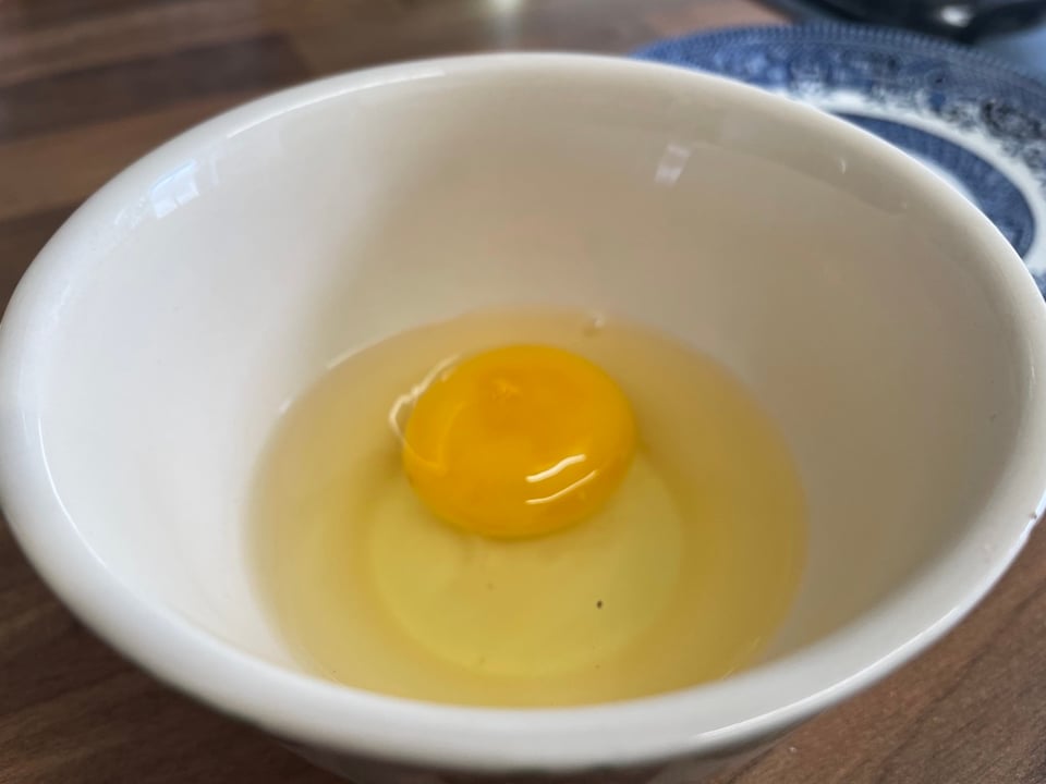A raw egg in a bowl
