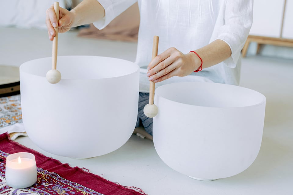 Image of person playing crystal bowls