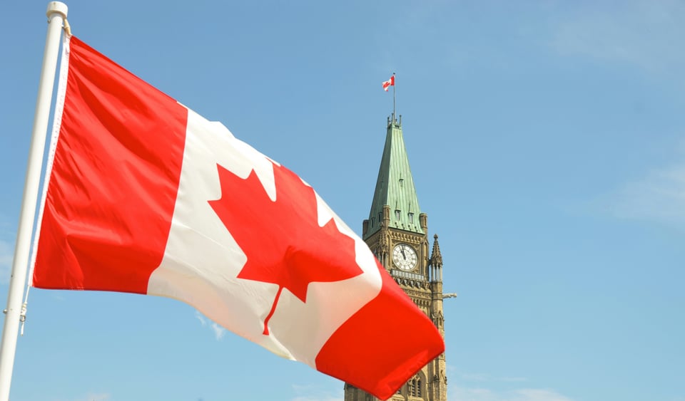Canadian flag flies in front of Parliament