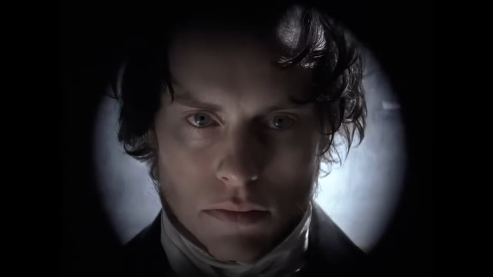 A Victorian man stares into the camera