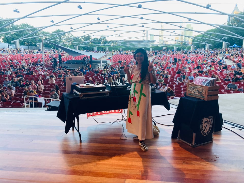 Marites DJing on the stage at Pritzker Pavilion in Millennium Park.