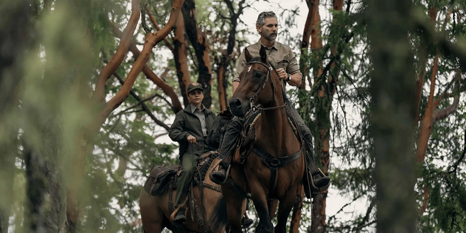 A still from Untamed on Netflix, with Eric Bana as Kyle Turner and Lily Santiago as Naya Vasquez on horseback in the woods.