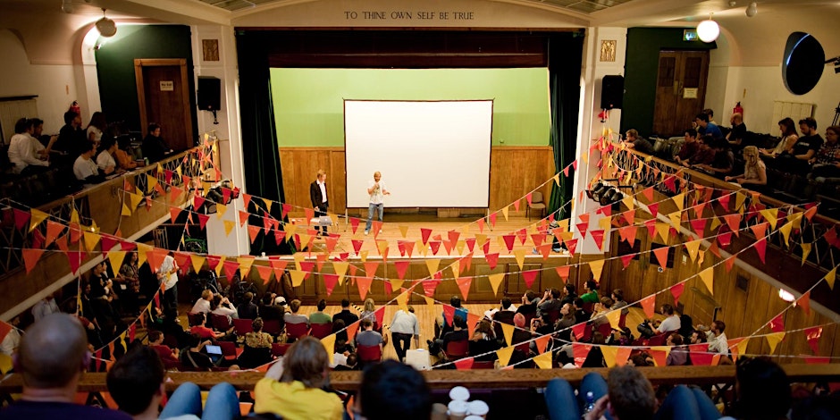 Someone on stage at The Conway Hall in London at a previous Interesting conference.