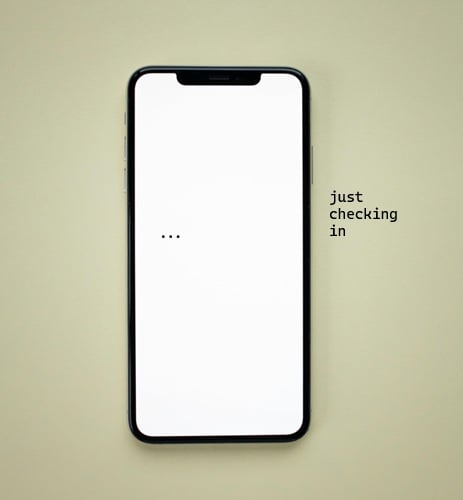 A picture of a blank smartphone with an ellipsis on the screen. Next to it in black text is the title "just checking in."